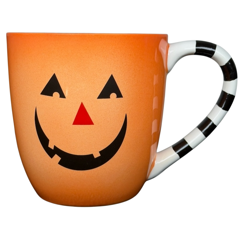 Hallmark Halloween Jack-O'-Lantern vintage mug with a smiling pumpkin design and striped handle