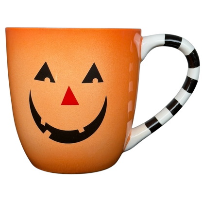 Hallmark Halloween Jack-O'-Lantern vintage mug with a smiling pumpkin design and striped handle