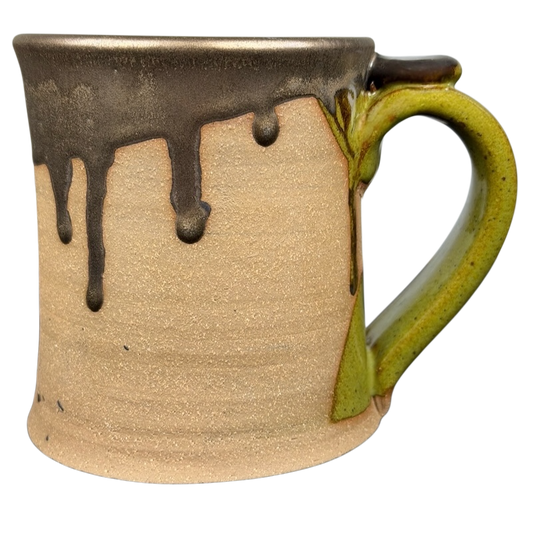 Unique handcrafted drip glaze K Mo pottery mug with a green handle and brown glaze drips