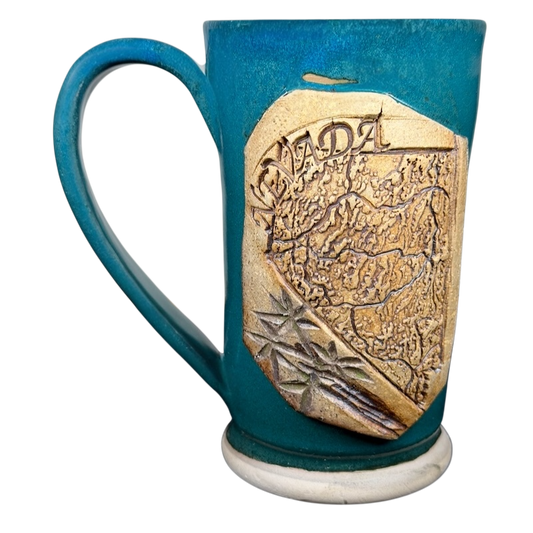 Handcrafted Nevada map pottery mug with detailed embossed state design and vibrant blue glaze