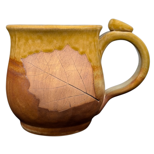 Handcrafted studio pottery leaf mug with a natural leaf design and warm earthy tones
