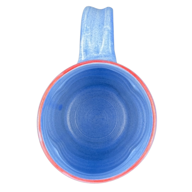 Rebecca Lowery vintage blue pottery mug top down view showing blue glaze red rim and handle on black background