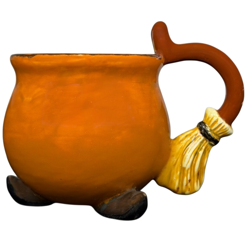 Handmade witch cauldron mug in orange with a broomstick handle and round base