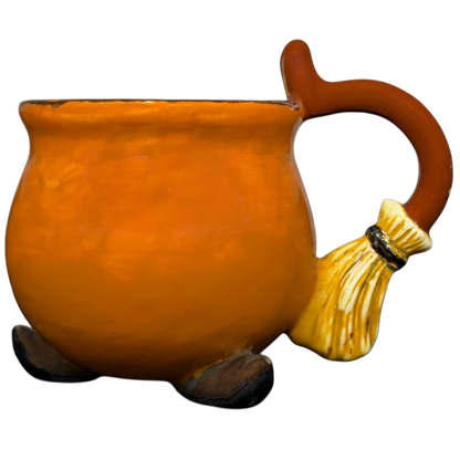 Handmade witch cauldron mug in orange with a broomstick handle and round base
