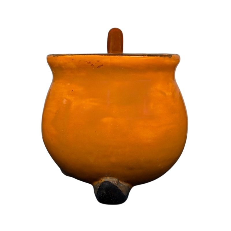 Handmade witch cauldron mug in orange ceramic with a sturdy handle and round base