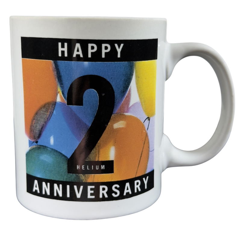 Happy Helium Anniversary Mug Collectible featuring colorful balloons and a bold '2'