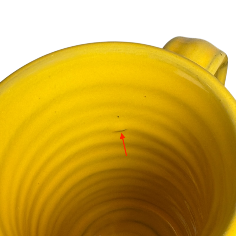 Inside view of a Hell's Backbone Deneen Pottery yellow mug 2014 showcasing its smooth texture and vibrant color