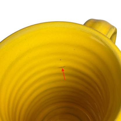 Inside view of a Hell's Backbone Deneen Pottery yellow mug 2014 showcasing its smooth texture and vibrant color