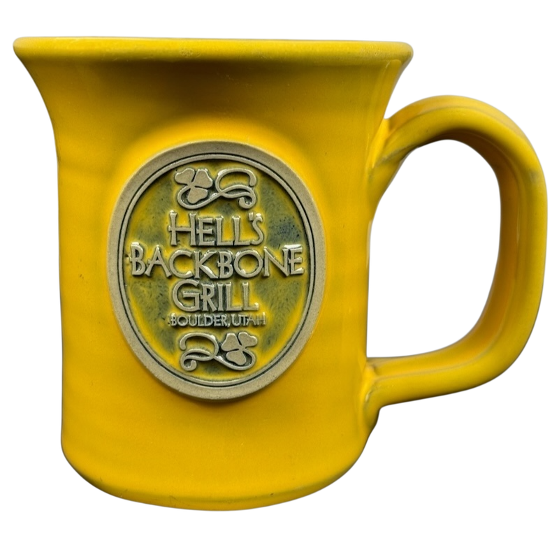 Hell's Backbone Deneen Pottery yellow mug 2014 with an embossed logo for stylish drinkware