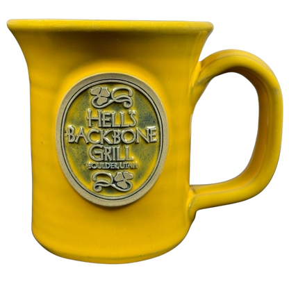 Hell's Backbone Deneen Pottery yellow mug 2014 with an embossed logo for stylish drinkware