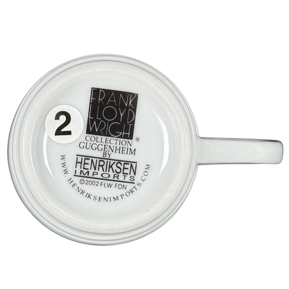 Bottom view of white Frank Lloyd Wright vintage Guggenheim mug showing Henriksen Imports stamp and number sticker