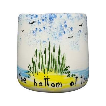 Hidden frog vintage pottery mug with hand-painted scenery of plants and birds against a blue sky