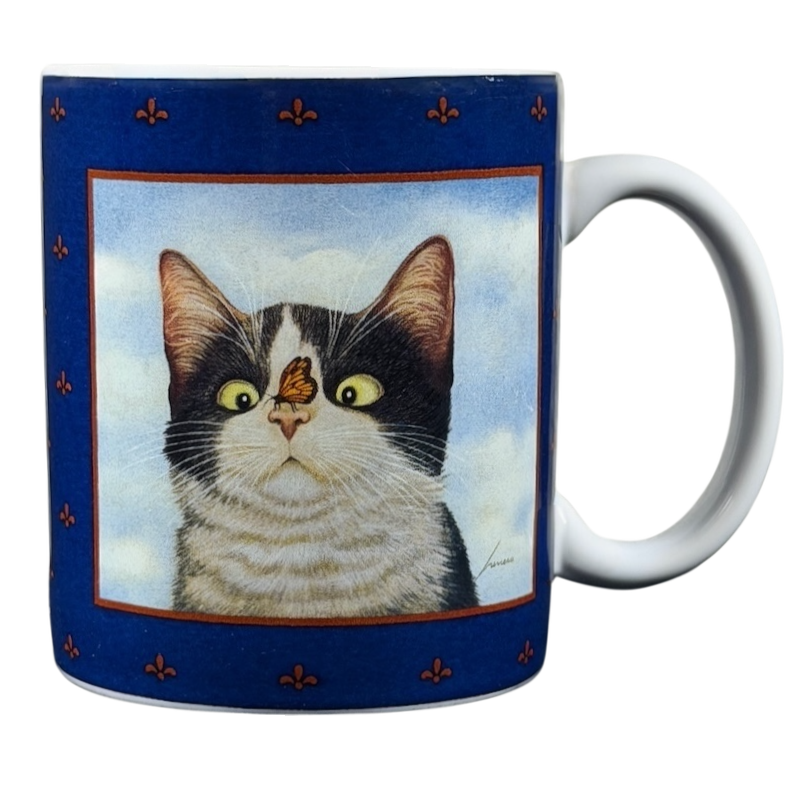 Hugo Hege cat Lang & Wise mug featuring a cat with a butterfly on its nose against a blue background