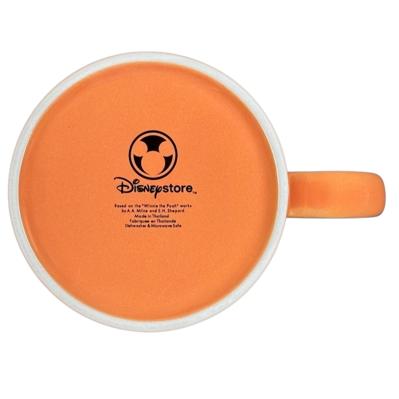 Bottom view of Hunny Pooh 1966 collectible Disney mug featuring a vibrant orange interior design