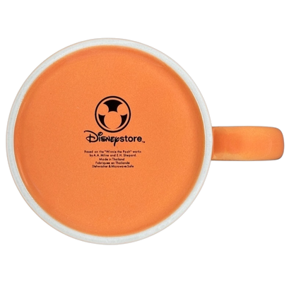 Bottom view of Hunny Pooh 1966 collectible Disney mug featuring a vibrant orange interior design