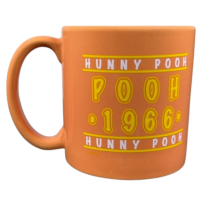 Hunny Pooh 1966 collectible Disney mug in orange with playful text design