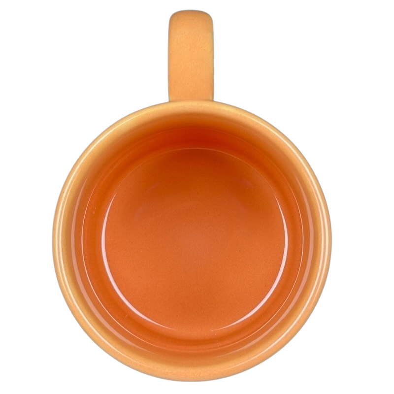 Top view of Hunny Pooh 1966 collectible Disney mug showcasing its orange interior and smooth finish