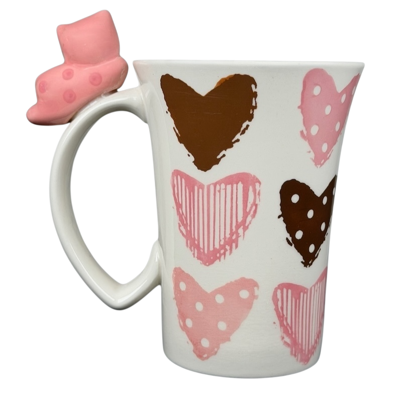 Indra Heart Polka Dot Piggy handle mug featuring colorful hearts and a unique piggy handle design