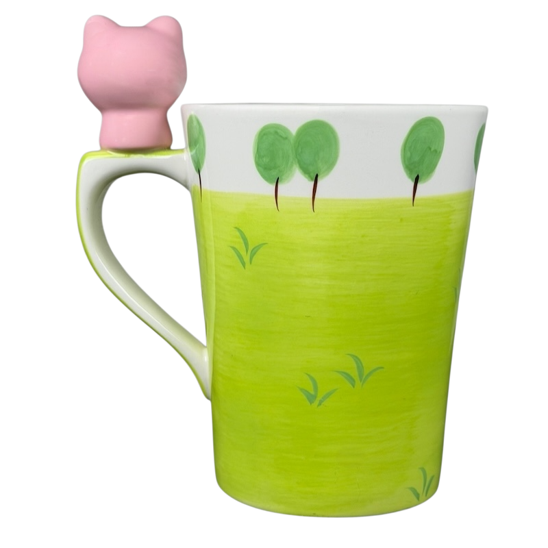 Indra vintage pig handle mug with a playful pink pig design and vibrant green base for unique drinkware