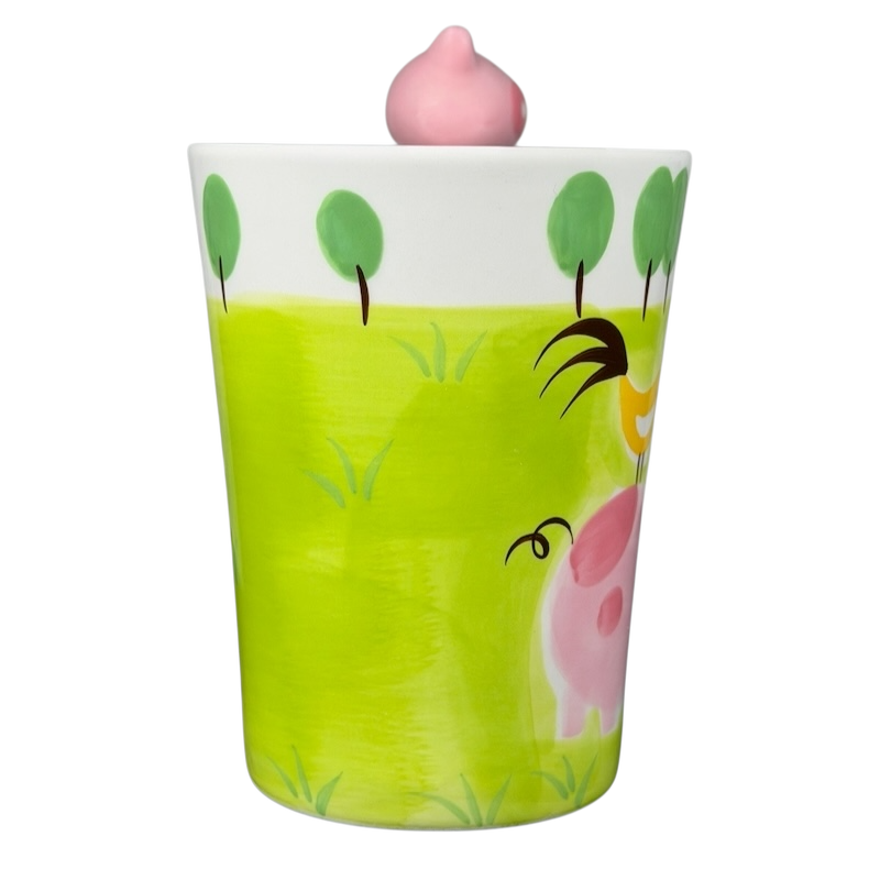 Indra vintage pig handle mug features playful design with pink pig and green grass for a fun drinking experience