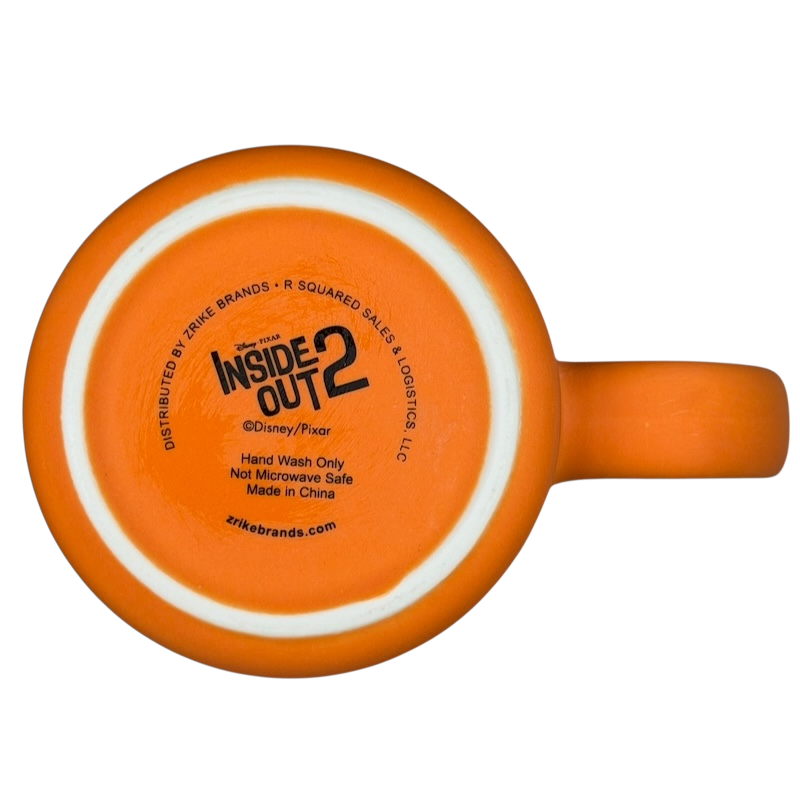 Inside Out 2 Anxiety mug in bright orange with hand wash only care instructions on the bottom