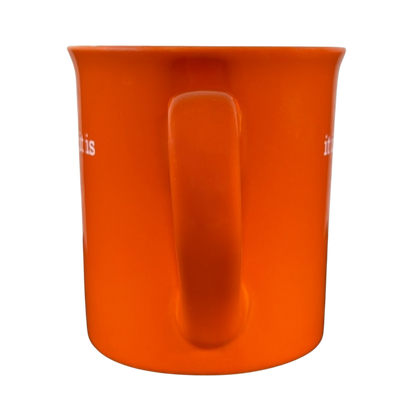 Bright orange it is what it is vintage mug with a sturdy handle on black background