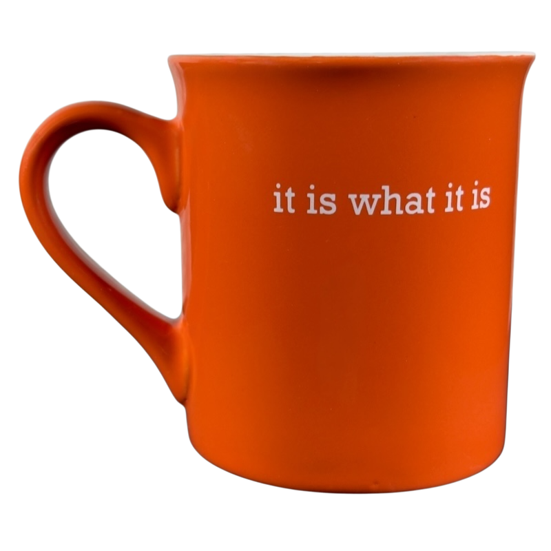 Orange ceramic it is what it is vintage mug with white text on the side and a large handle