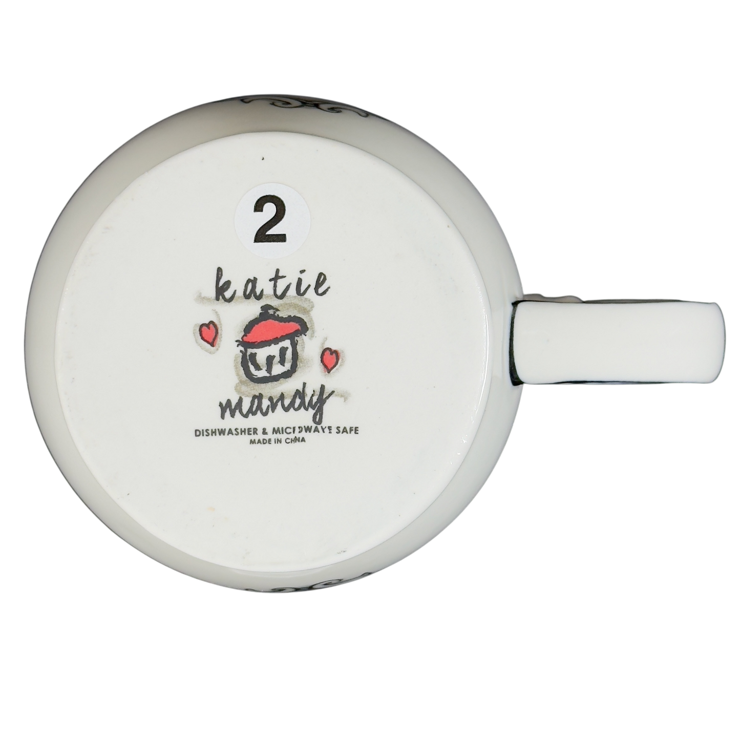 Bottom view of Katie Mandy collectible mug with logo and dishwasher safe label
