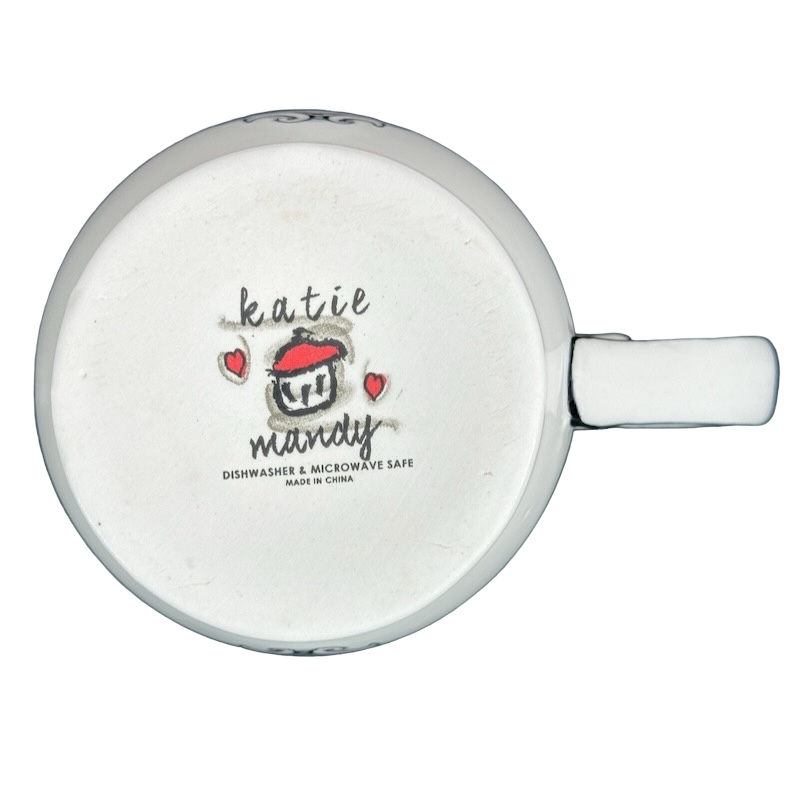 Bottom view of Katie Mandy collectible mug showing logo and dishwasher microwave safe label