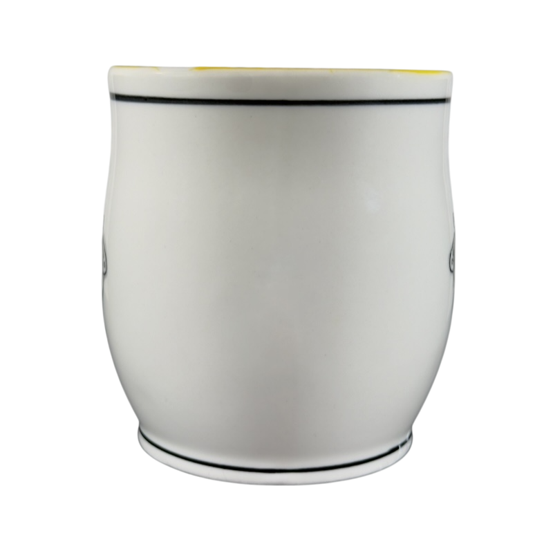 White ceramic Katie Mandy collectible mug with black trim on top and bottom edges