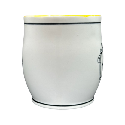 White ceramic Katie Mandy collectible mug with a smooth curved design and thin black rim lines