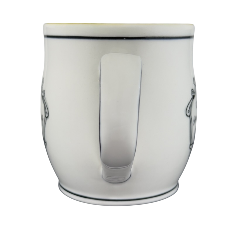 White ceramic Katie Mandy collectible mug with black decorative accents shown from the back