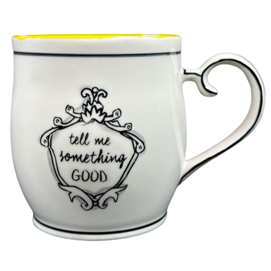 Katie Mandy collectible mug with ornate black design and phrase tell me something good in black script