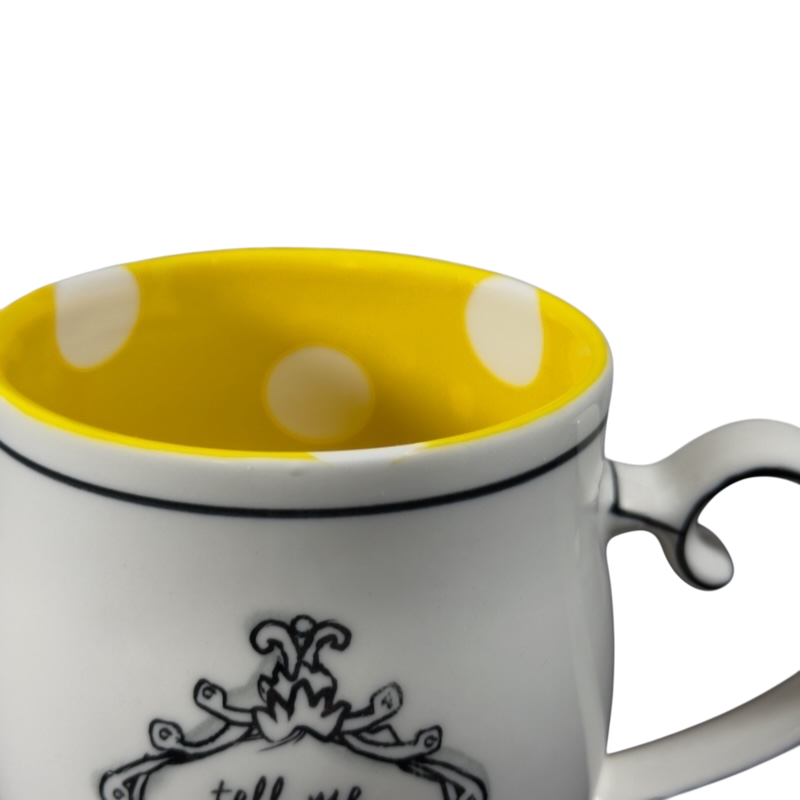 Katie Mandy collectible mug with yellow polka dot interior and decorative black design on white exterior