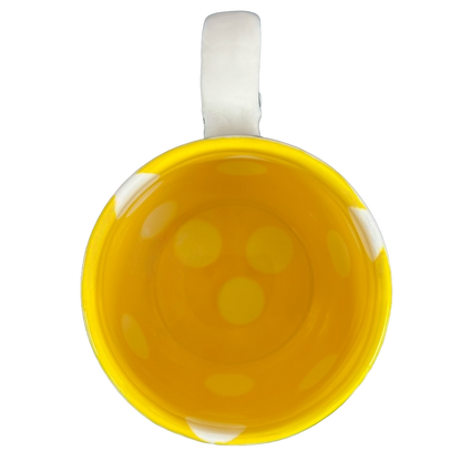 Top view of Katie Mandy collectible mug with bright yellow interior and white handle