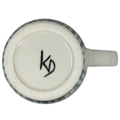 Bottom view of Karen Donleavy Bichon Frise mug showing artist KD signature on ceramic base and handle