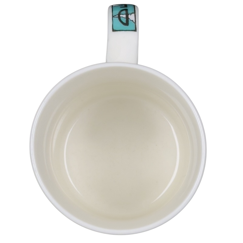 Top view of Decaf Kris Fisher Chaleur mug white ceramic with cream interior and turquoise handle accent