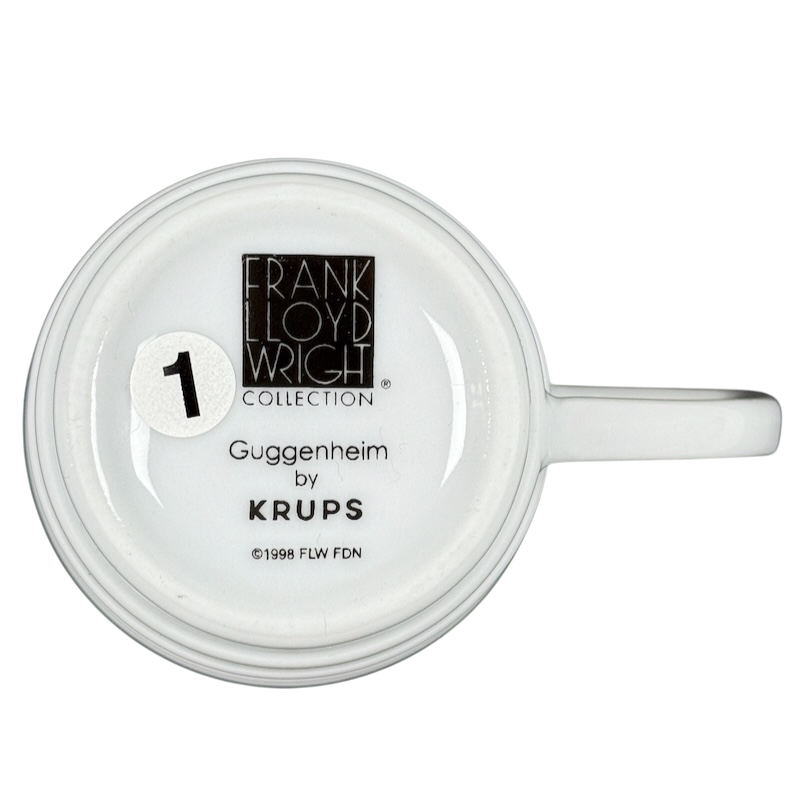 Bottom view of white Krups mug showing Frank Lloyd Wright Collection logo and text Frank Lloyd Wright vintage Guggenheim mug