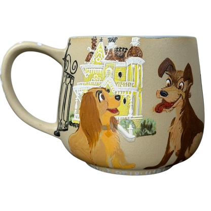 Lady and the Tramp hand-painted pottery mug featuring vibrant dog characters against a colorful backdrop