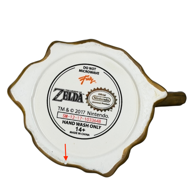 Bottom view of Legend Of Zelda Deku Tree Nintendo Mug Just Funky with care instructions and branding details
