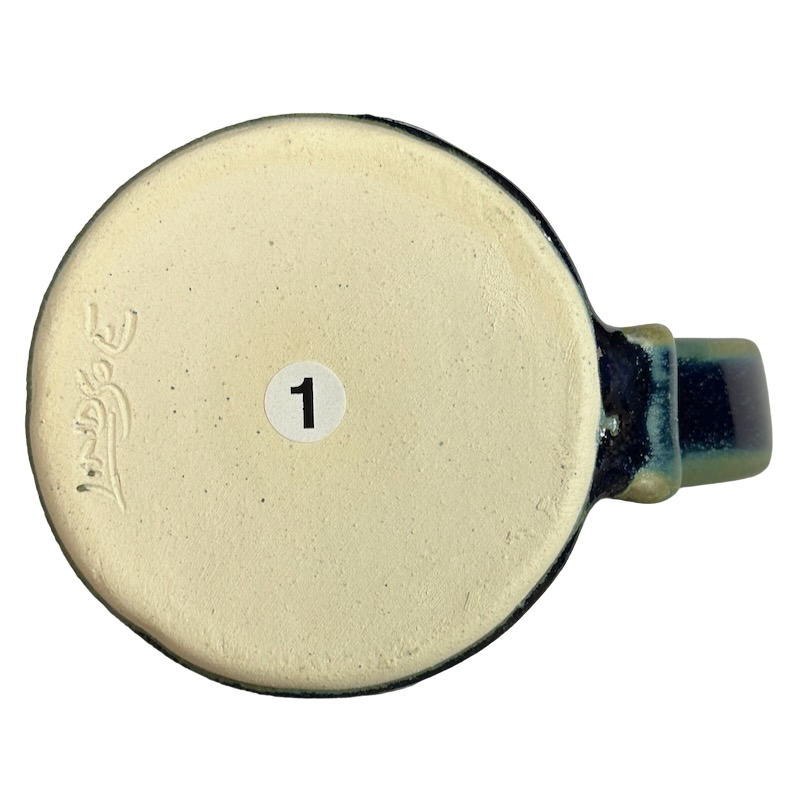 Bottom view of a green blue signed Lindsoe Clayworks mug showcasing its artisan design.