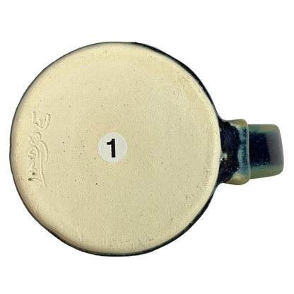 Bottom view of a green blue signed Lindsoe Clayworks mug showcasing its artisan design.