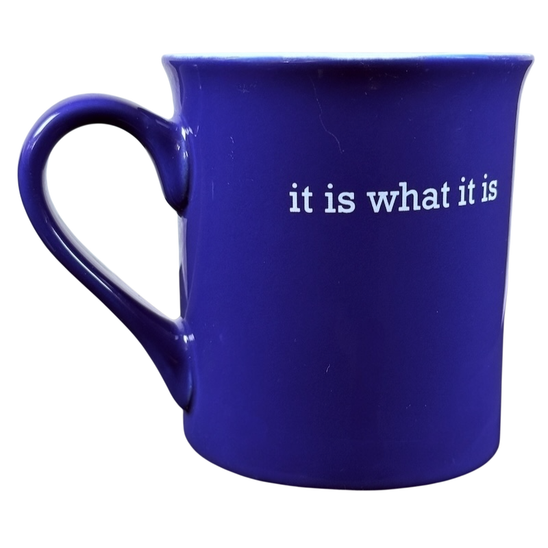 Dark blue ceramic coffee mug with white it is what it is Love Your Mug printed text and curved handle