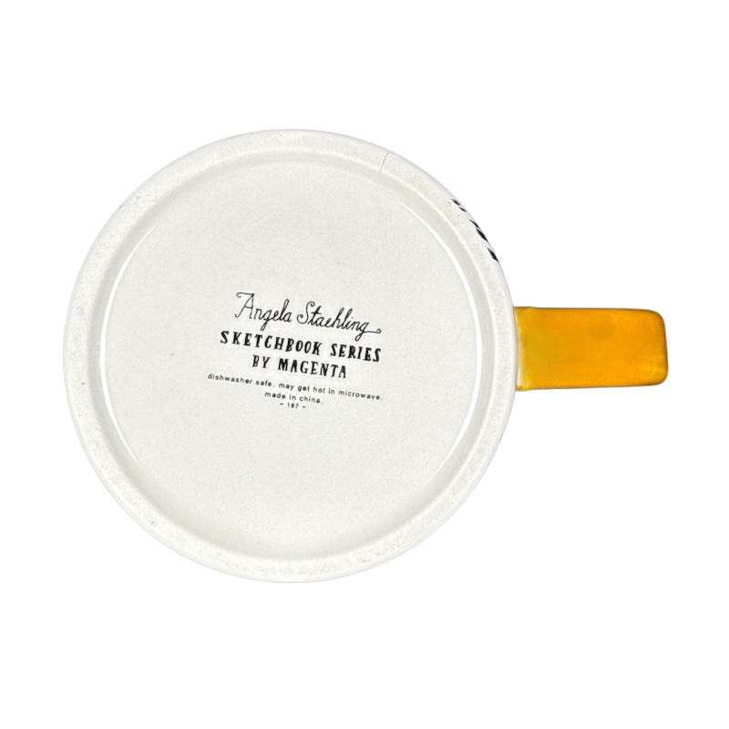 Bottom view of white ceramic mug with yellow handle showing Angela Staehling Halloween collectible mug stamp by Magenta