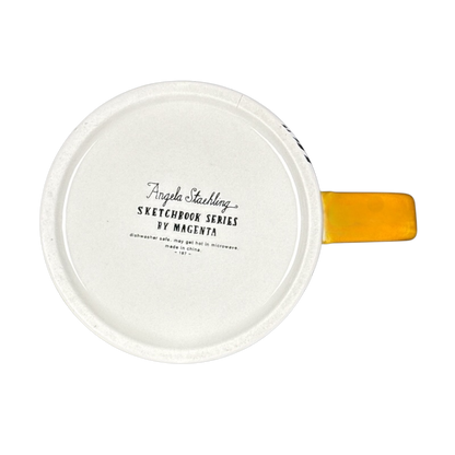 Bottom view of white ceramic mug with yellow handle showing Angela Staehling Halloween collectible mug stamp by Magenta