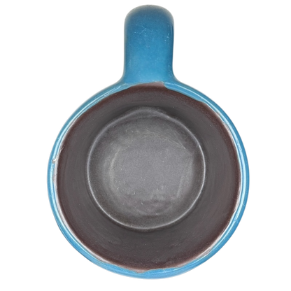 Top view of Mara Mexico pottery mug horse featuring a vibrant blue exterior and dark interior