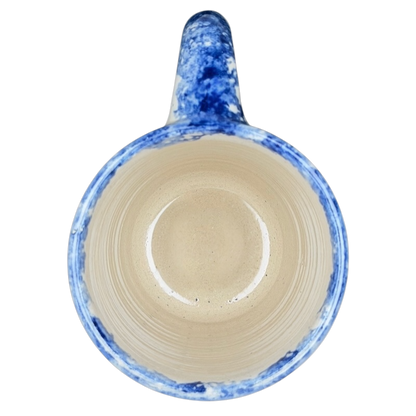 Texas Bluebonnet Pottery Mug Marshall Brand with a blue and beige speckled interior design
