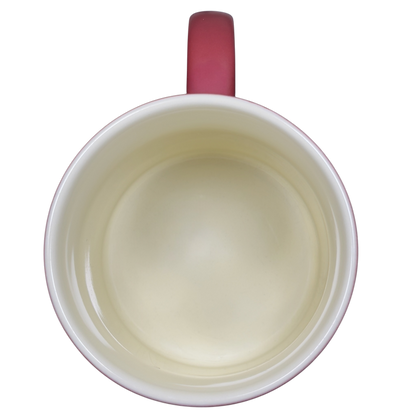 Inside view of a Mickey Mouse vintage smile mug with a cream interior and red handle