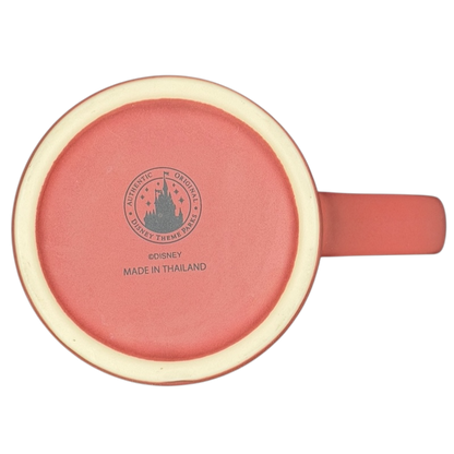 Bottom view of a Disney Minnie Mouse 5 Poses Disneyland Mug with a coral color and logo detailing