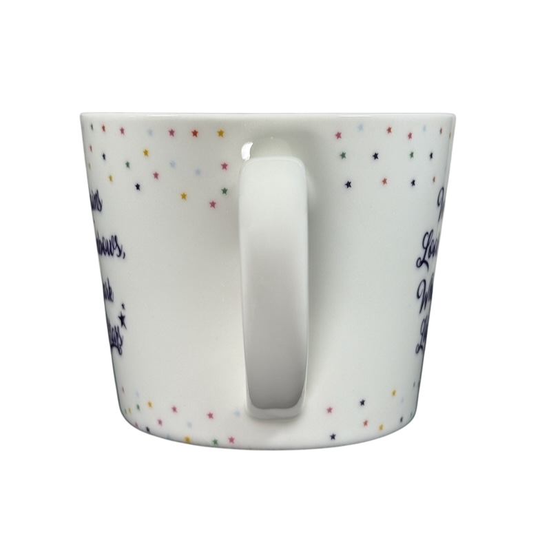 Cooksmart When It Rains Look For Rainbows mug white ceramic with handle center multicolored star pattern and navy script on black